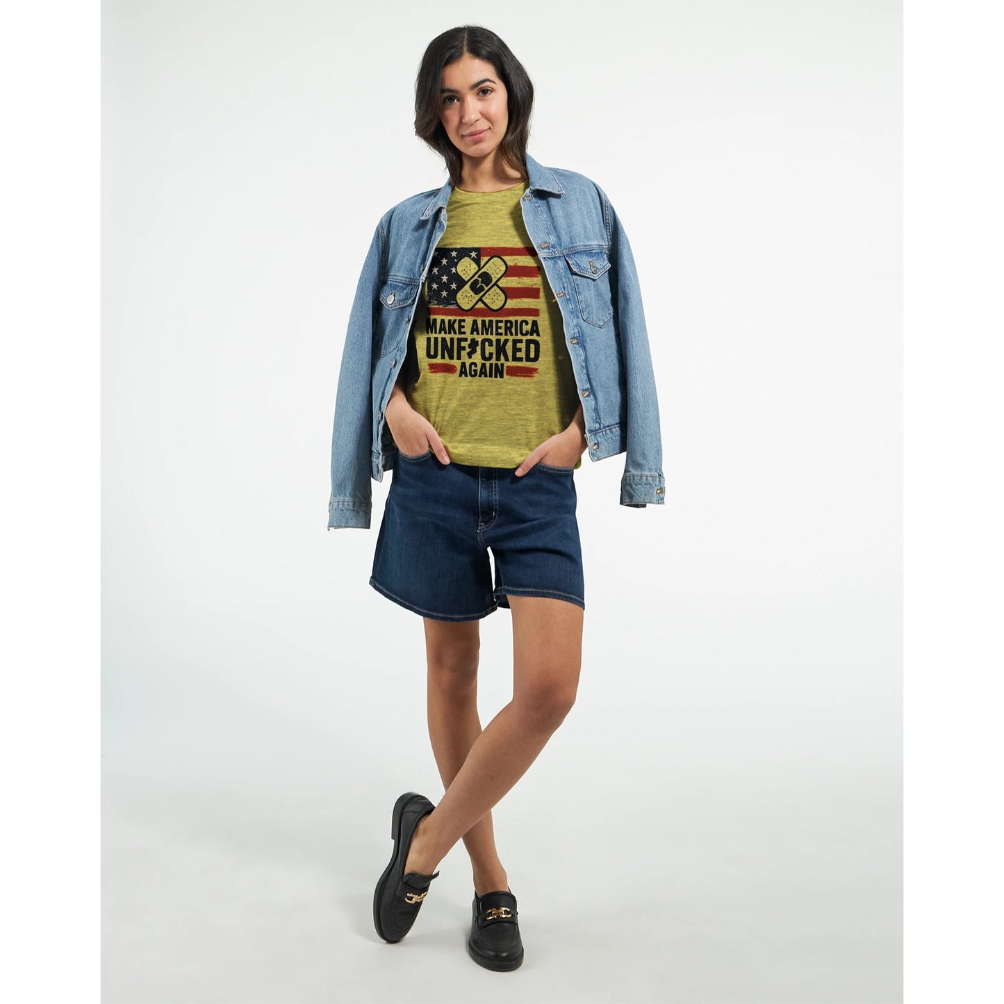 Yellow t-shirt with a distressed USA flag and crossed bandage graphic above the slogan “Make America Unf*cked Again.”
