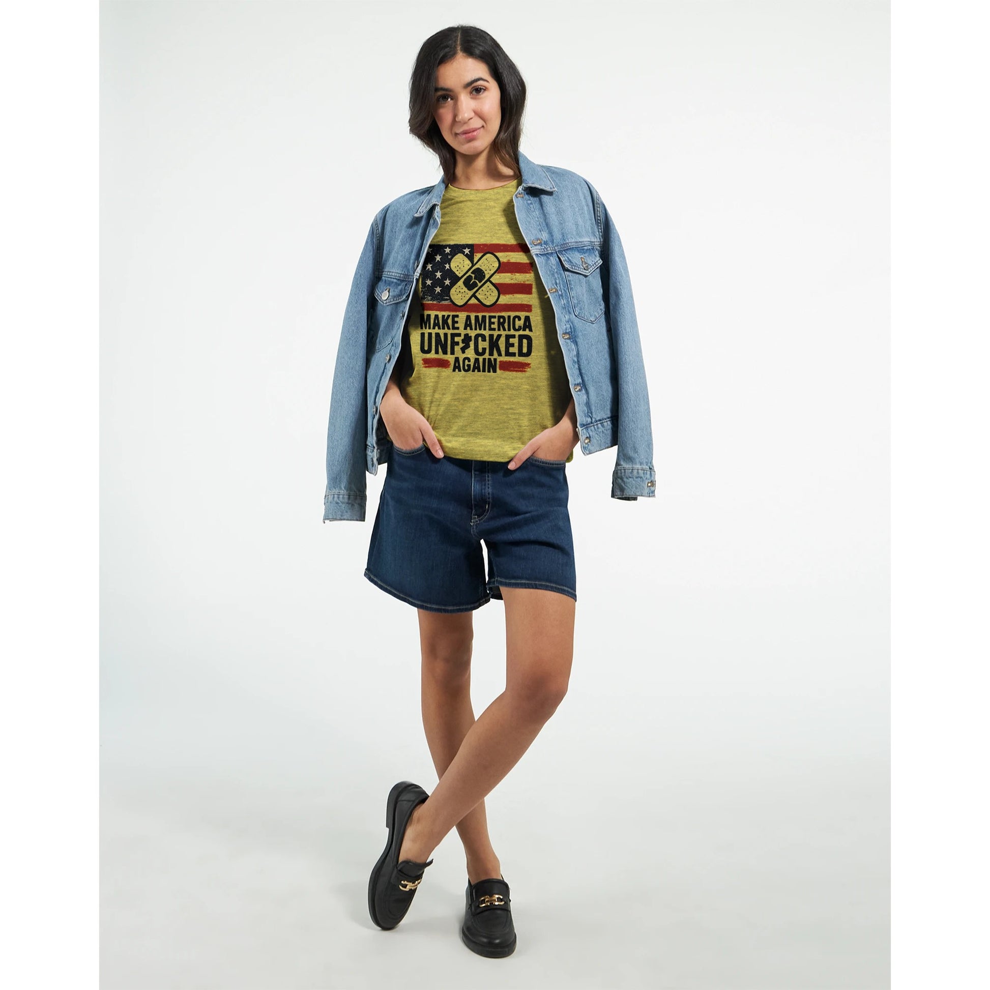 Yellow t-shirt with a distressed USA flag and crossed bandage graphic above the slogan “Make America Unf*cked Again.”
